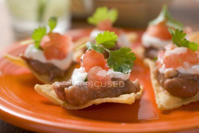 Nachos with beans and sour cream — Stock Photo