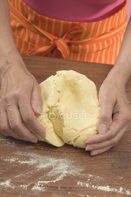 Cropped view of woman kneading tortilla dough — Stock Photo