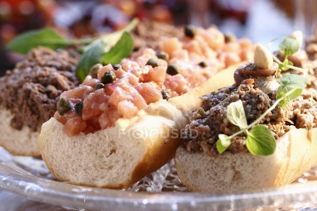 Baguettes with various toppings — Stock Photo