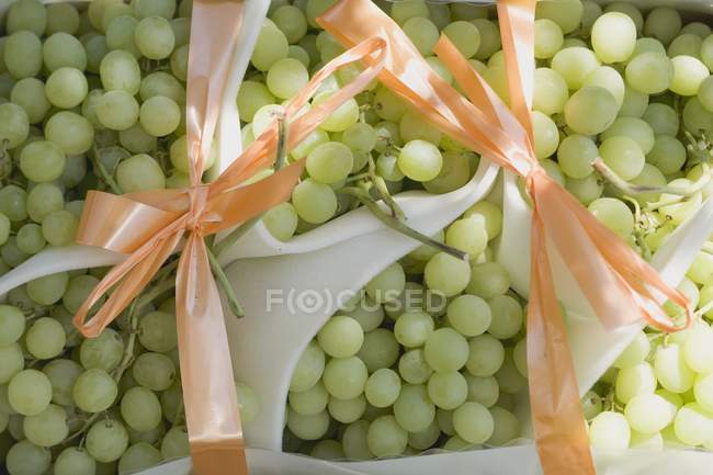 Green grapes with bows — Stock Photo