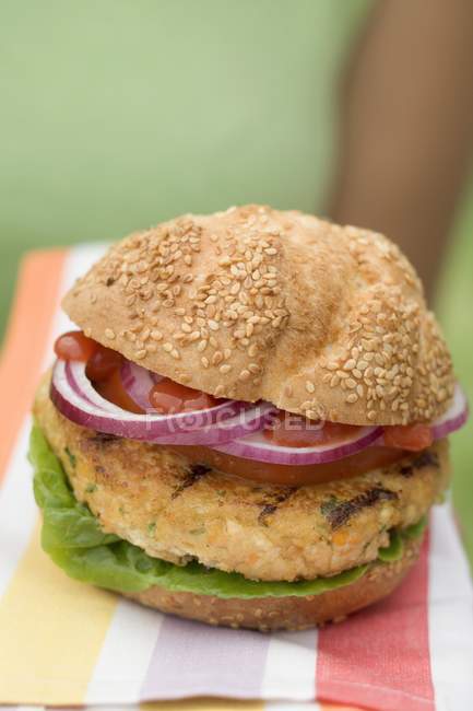 Woman holding grilled vegetable burger — Stock Photo