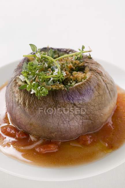 Stuffed Thai aubergine in tomato sauce on white plate — Stock Photo