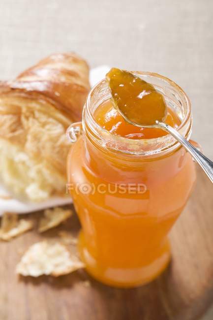 Apricot jam and croissant — Stock Photo