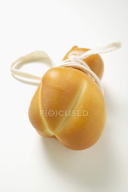 Provolone cheese with thread — Stock Photo
