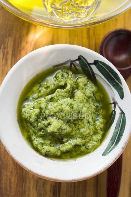 Closeup top view of Pesto in small bowl and oil — Stock Photo