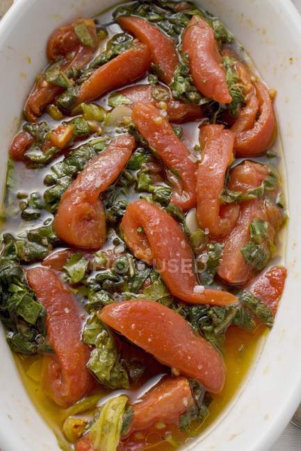 Tomatoes and savoy cabbage in white dish — Stock Photo