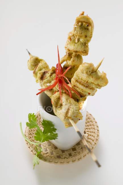 Spicy satay with chili pepper on white background — Stock Photo