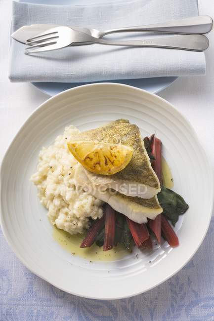 Sea bass fillets with risotto rice — Stock Photo