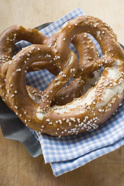 Salted pretzels on checked cloth — Stock Photo