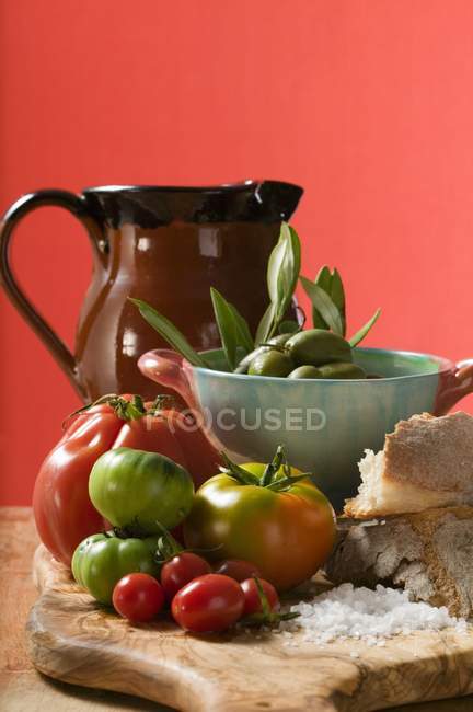 Fresh tomatoes on wooden table — Stock Photo