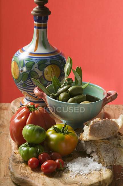 Fresh tomatoes on wooden table — Stock Photo