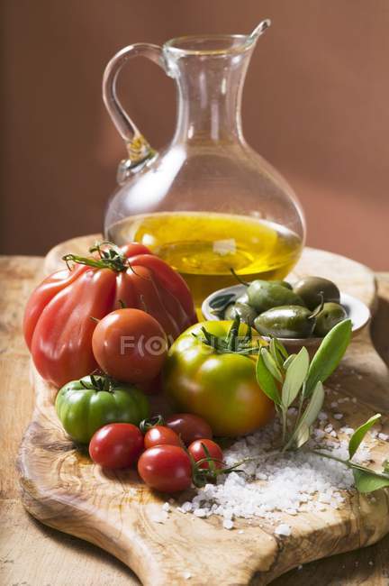Fresh tomatoes with olives — Stock Photo