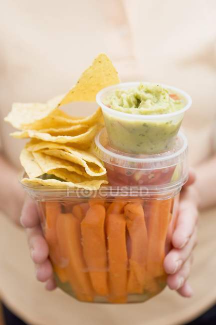 Woman holding plastic containers of vegetables — Stock Photo