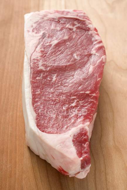 Beef steak on wooden — Stock Photo