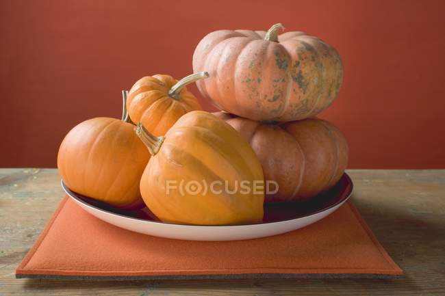 Orange pumpkins on plate — Stock Photo