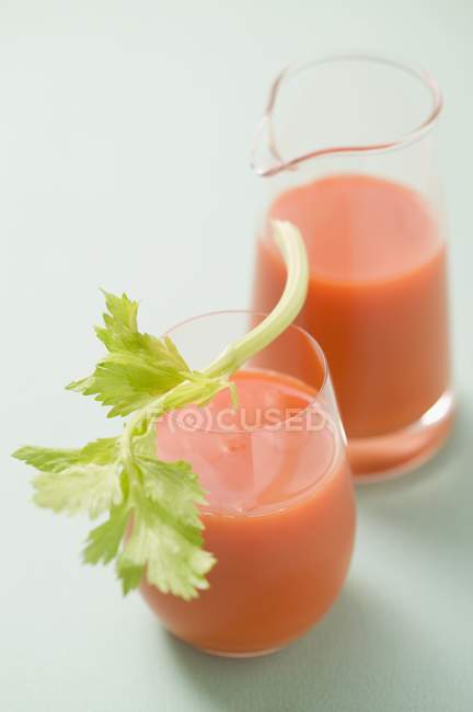 Glass of carrot juice with celery — Stock Photo