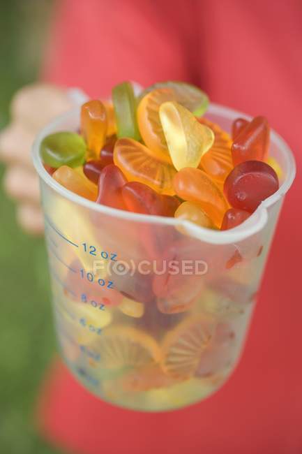 Measuring jug full of jelly sweets — Stock Photo