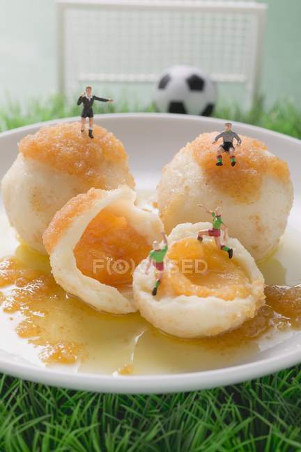 Closeup view of apricot dumplings with football figures — Stock Photo