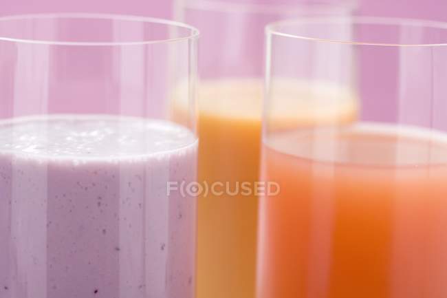 Blueberry milk and two different juices — Stock Photo