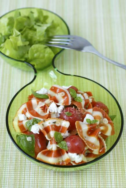 Coloured farfalle with tomatoes — Stock Photo