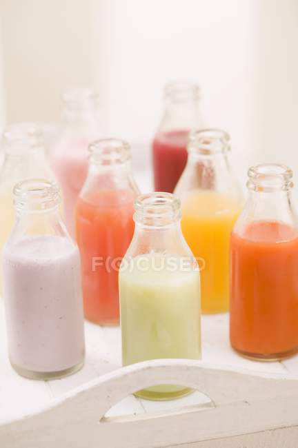 Various different juices in bottles — Stock Photo
