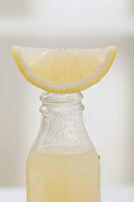 Lemon juice in glass bottle — Stock Photo