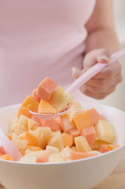 Mujer tomando cucharada de ensalada - foto de stock