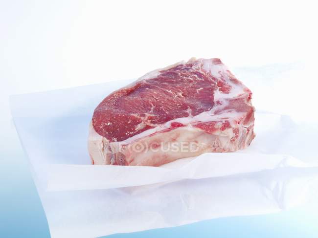 Ribeye steak on paper — Stock Photo