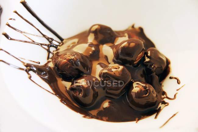 Avellanas en chocolate derretido - foto de stock