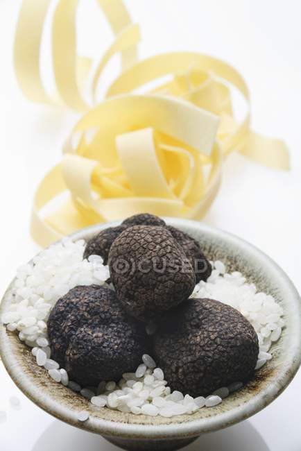 Black truffles and risotto rice — Stock Photo