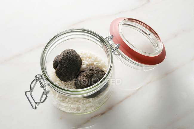 Black truffles and risotto rice — Stock Photo