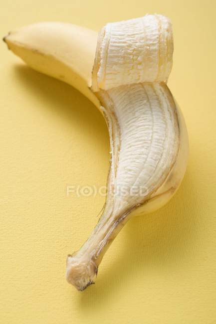 Partly peeled fresh banana — Stock Photo