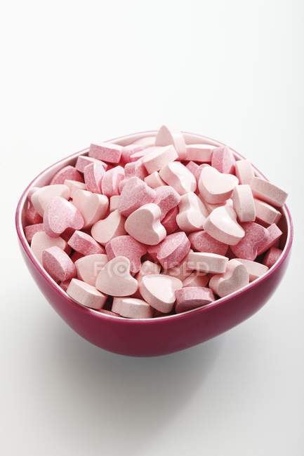 Vista close-up de corações de glicose rosa na tigela — Fotografia de Stock