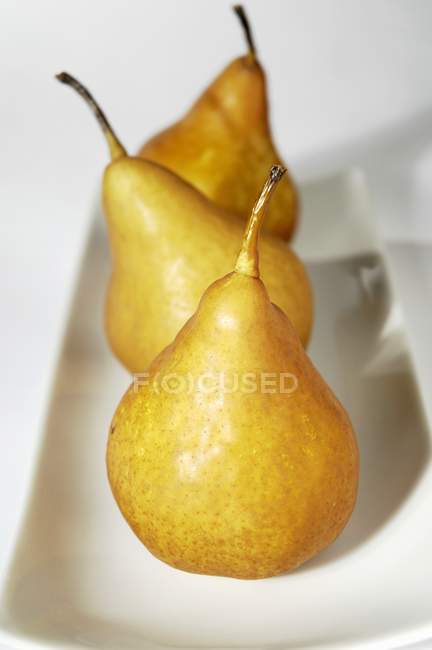 Três peras amarelas — Fotografia de Stock