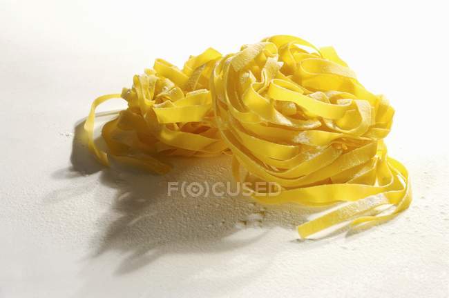 Fresh nest of tagliatelle pasta — Stock Photo