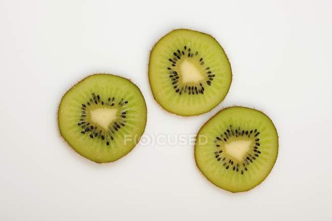 Three slices of kiwi fruit — Stock Photo