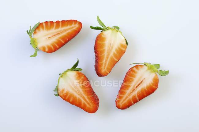 Fresas frescas cortadas a la mitad - foto de stock
