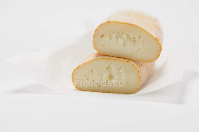 Cow's milk cheese on paper — Stock Photo