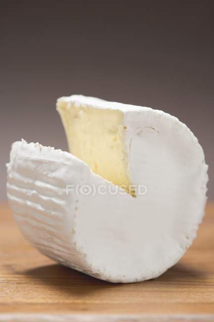 Goat's cheese on wooden desk — Stock Photo