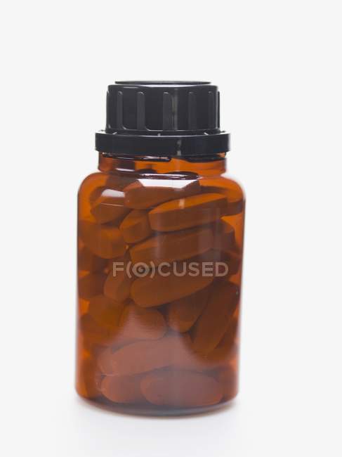 Primer plano del frasco de comprimidos - foto de stock