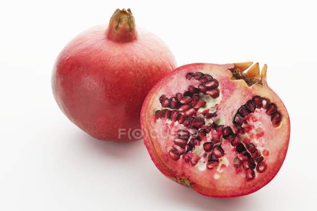 Fresh pomegranate and half — Stock Photo