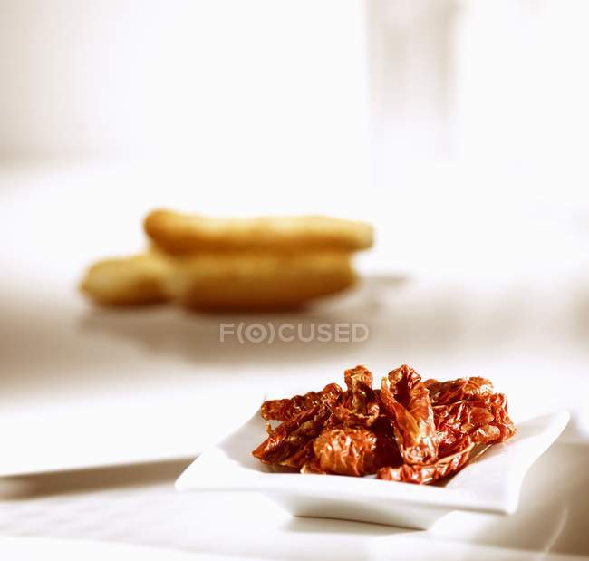Dried tomatoes in small dish — Stock Photo
