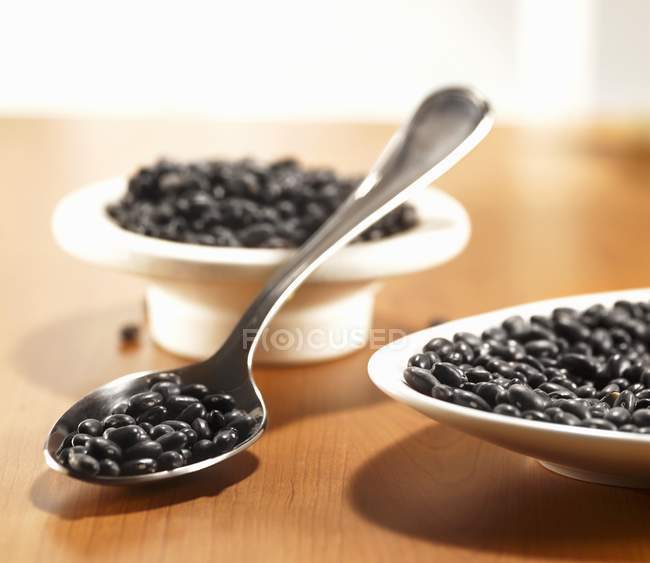 Raw Black beans in spoon — Stock Photo