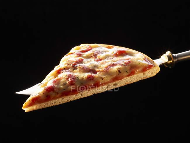 Rebanada de pizza a cuchillo - foto de stock