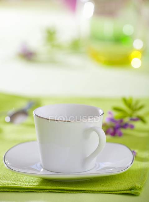 Vue rapprochée de tasse blanche et soucoupe avec jante argentée — Photo de stock