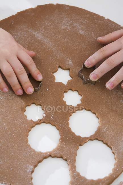 Children cutting biscuits — Stock Photo