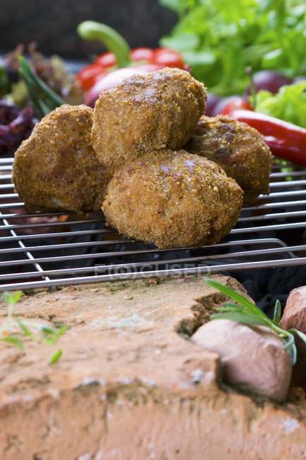Meatballs on barbecue rack — Stock Photo