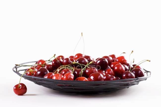 Cherries in wire plate — Stock Photo