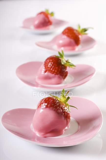Strawberries dipped in pink icing — Stock Photo