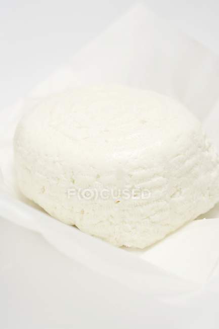Ricotta cheese on paper — Stock Photo